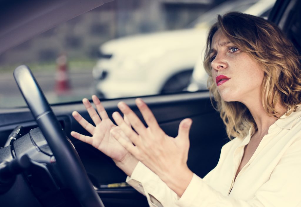 Frustrated woman stuck in traffic